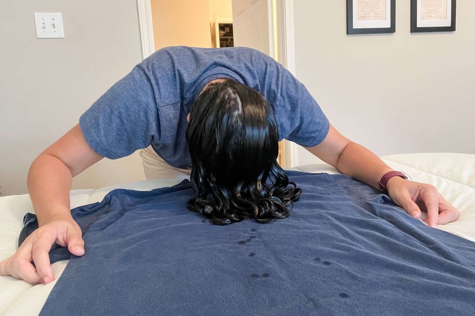 woman plopping curly hair on t-shirt